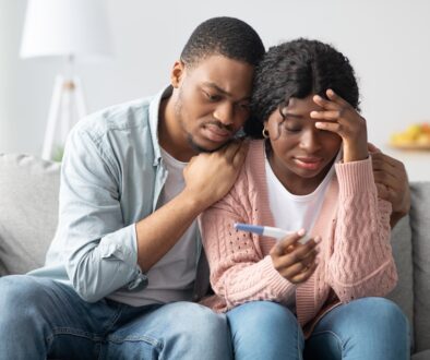 Depressed African-American Couple With Pregnancy Test Know It’s Time to See a Doctor for Infertility