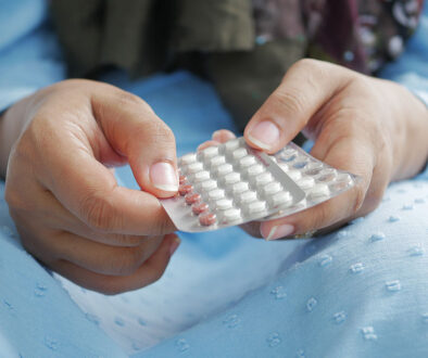 Closeup of a Woman’s Hands Holding a Pack of Birth Control Pills