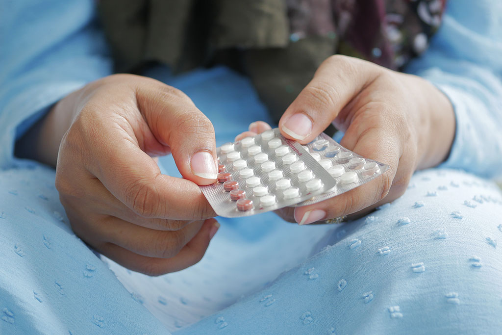 Closeup of a Woman’s Hands Holding a Pack of Birth Control Pills