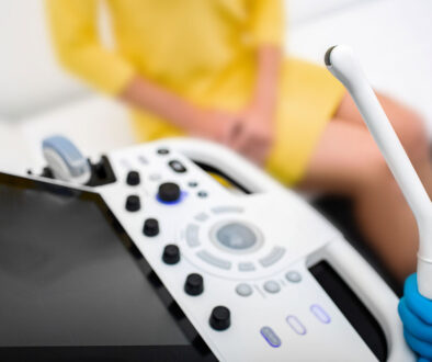 Closeup of a Gynecologist Holding a Sensor Wand With a Patient Sitting in the Background What Does a Transvaginal Ultrasound Show