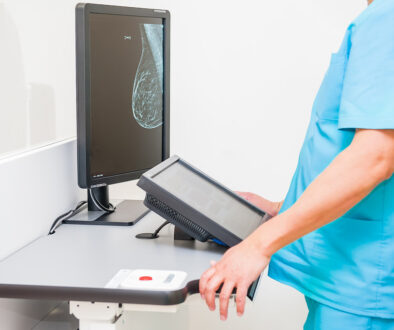 A Doctor Looking at a Computer Showing a Scan of a Woman’s Breast What Does Dense Breast Tissue Mean