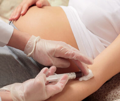 Closeup Of an Obgyn Doctor Removing A Syringe From A Pregnant Woman’s Arm During Non-Invasive Prenatal Testing